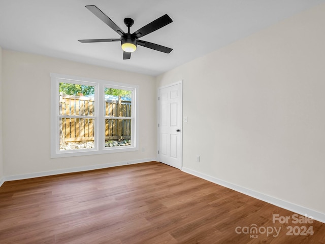 unfurnished room with hardwood / wood-style floors and ceiling fan