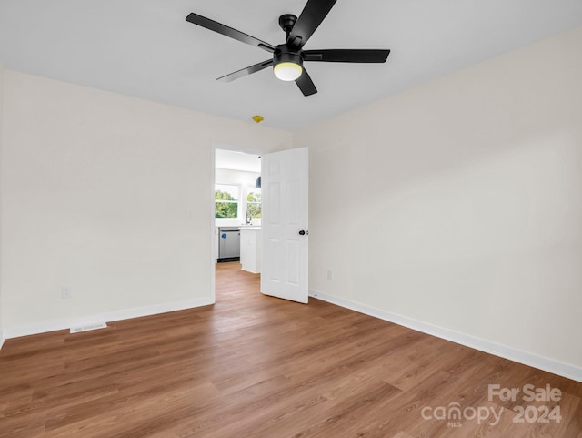 spare room with light hardwood / wood-style floors and ceiling fan