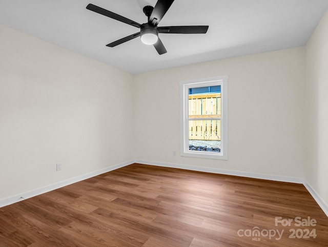 spare room featuring wood-type flooring and ceiling fan