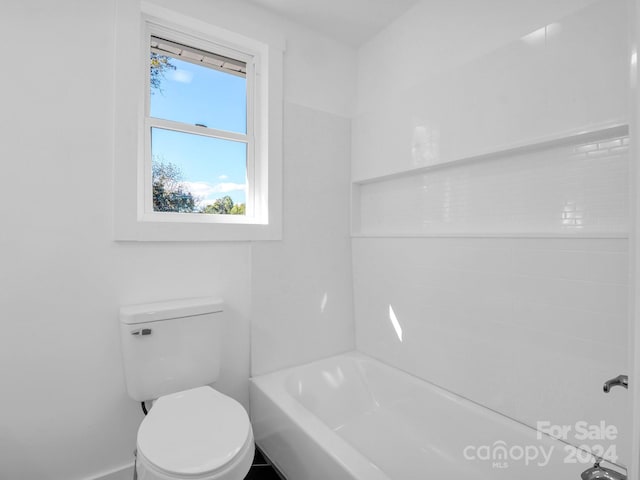 bathroom with toilet and tub / shower combination