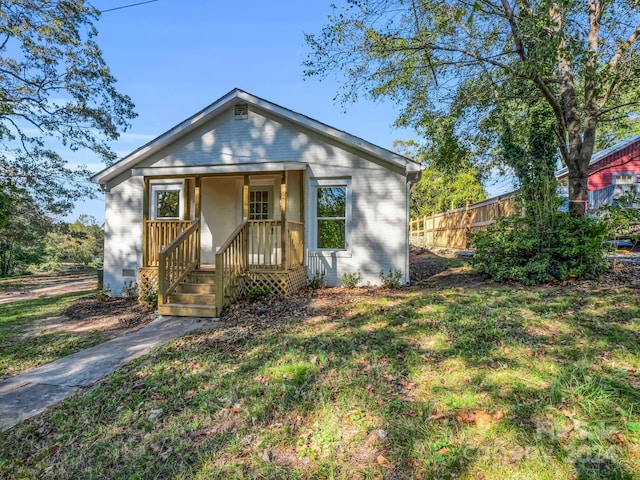 bungalow-style home with a front yard