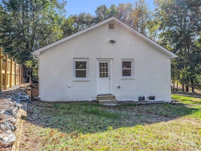 back of house with a yard