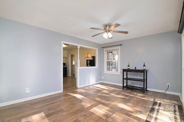 spare room featuring ceiling fan and dark hardwood / wood-style floors