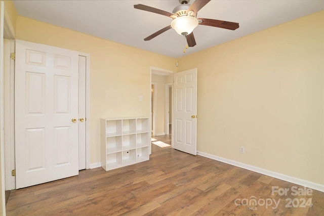 unfurnished bedroom featuring ceiling fan and hardwood / wood-style flooring