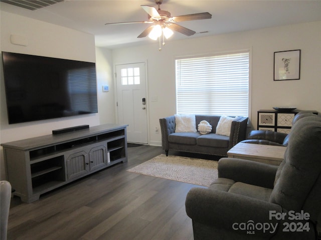 living room with ceiling fan and dark hardwood / wood-style flooring