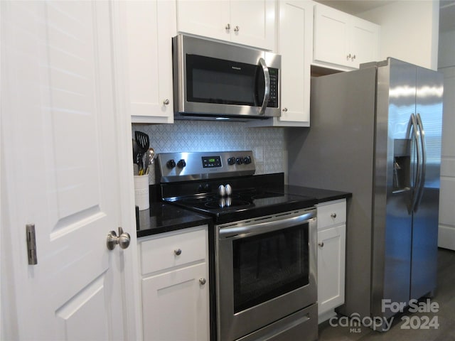 kitchen featuring white cabinetry, stainless steel appliances, and backsplash