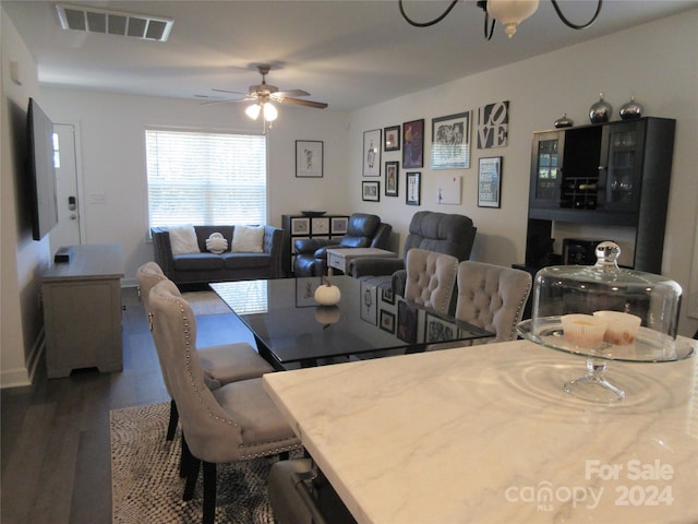 dining space featuring dark hardwood / wood-style floors and ceiling fan