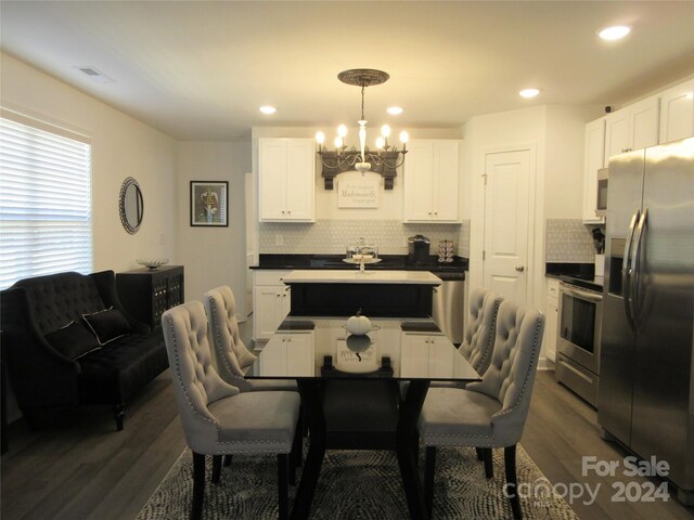 dining room featuring a notable chandelier and dark hardwood / wood-style floors