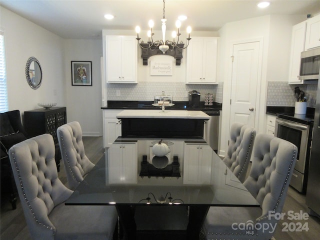 dining area featuring a notable chandelier and wood-type flooring