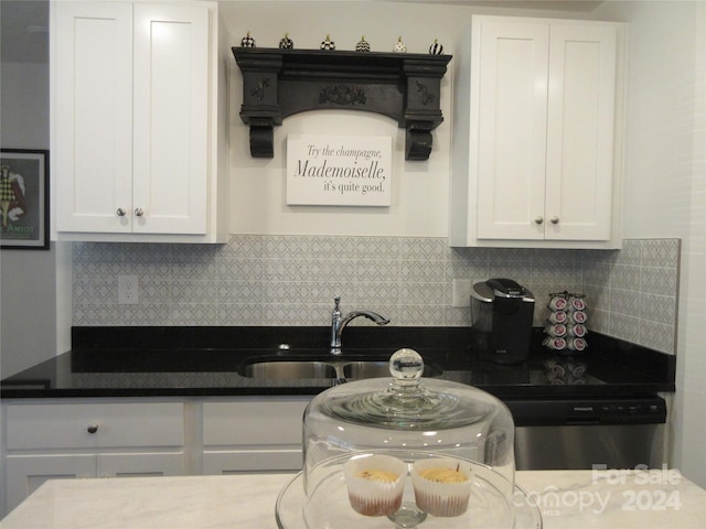 kitchen featuring tasteful backsplash, dishwasher, sink, and white cabinets