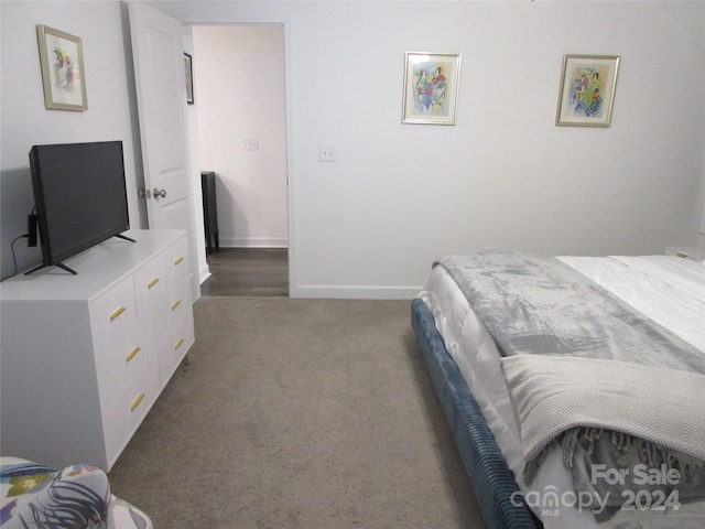 bedroom featuring dark carpet