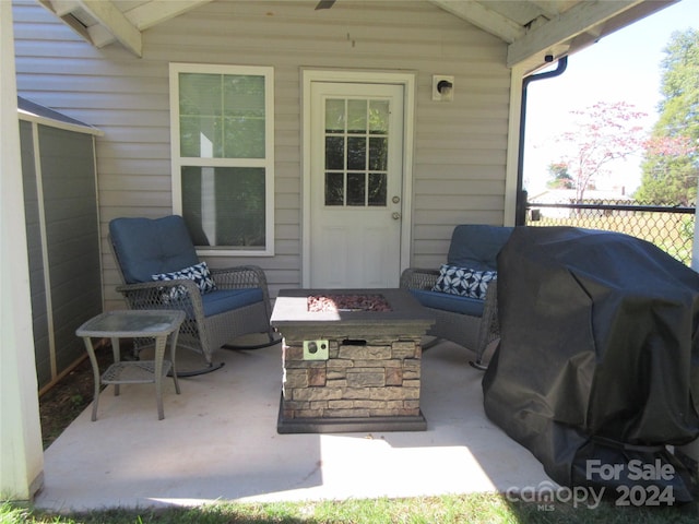 view of patio / terrace with a fire pit and a grill