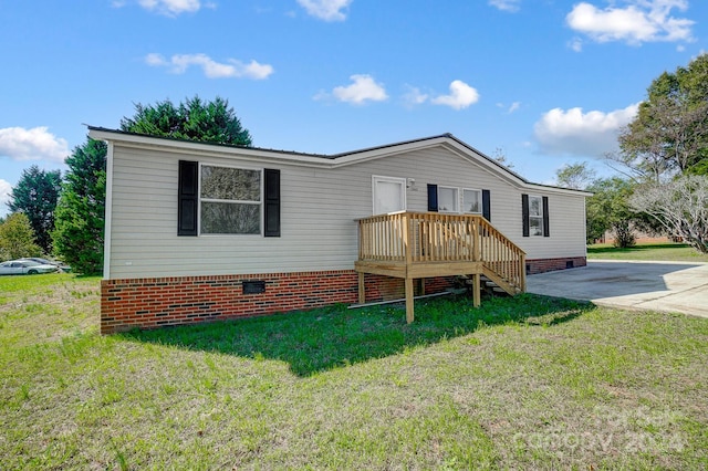 rear view of house featuring a lawn