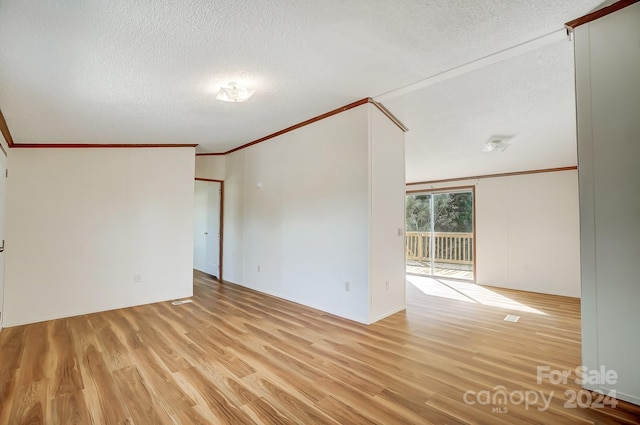 unfurnished room featuring a textured ceiling, light hardwood / wood-style flooring, and ornamental molding