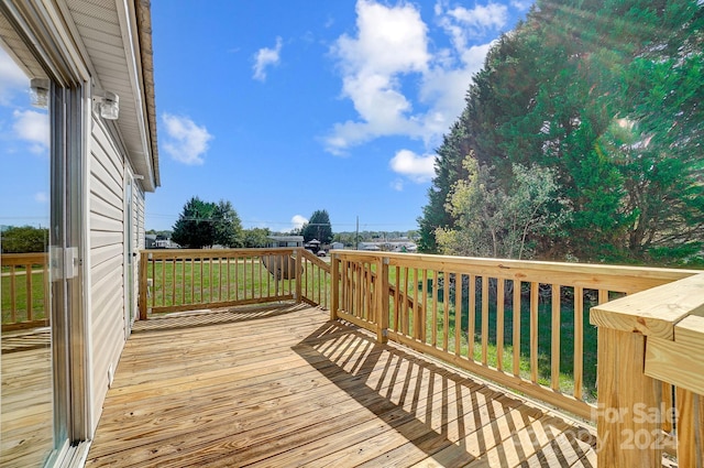 wooden terrace with a lawn