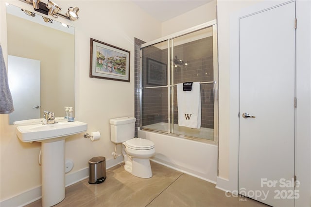 bathroom featuring bath / shower combo with glass door and toilet