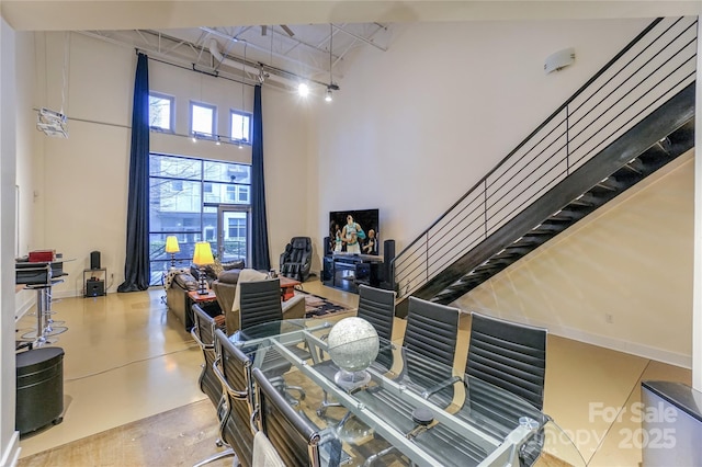 office with a towering ceiling and concrete floors