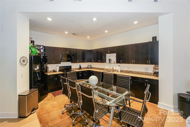 kitchen with sink, dark brown cabinetry, and black appliances