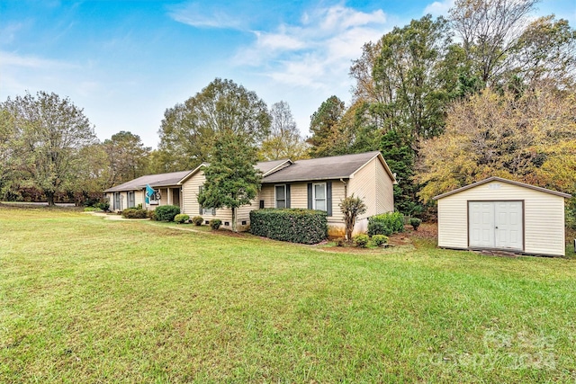 view of front of home featuring a front yard and a storage unit