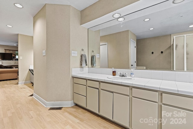 bathroom featuring vanity and hardwood / wood-style flooring