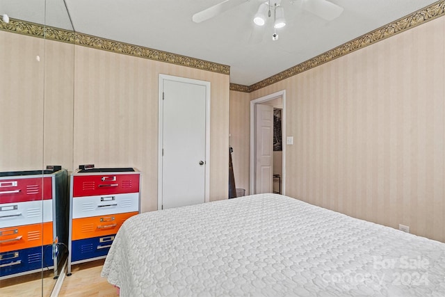 bedroom with hardwood / wood-style flooring and ceiling fan