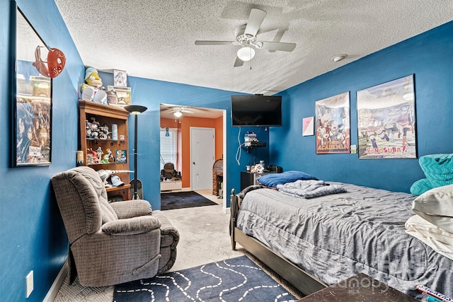 carpeted bedroom featuring a textured ceiling and ceiling fan