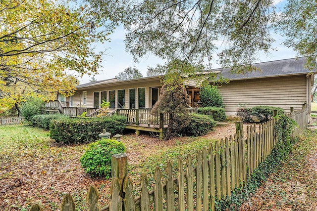 back of property featuring a wooden deck