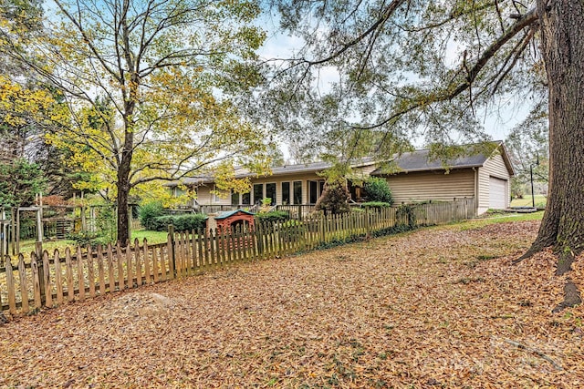 rear view of property featuring a garage