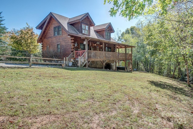 back of house featuring a deck and a lawn