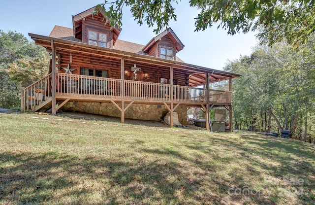 rear view of property with a yard and a deck