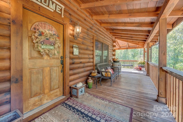 view of exterior entry with covered porch