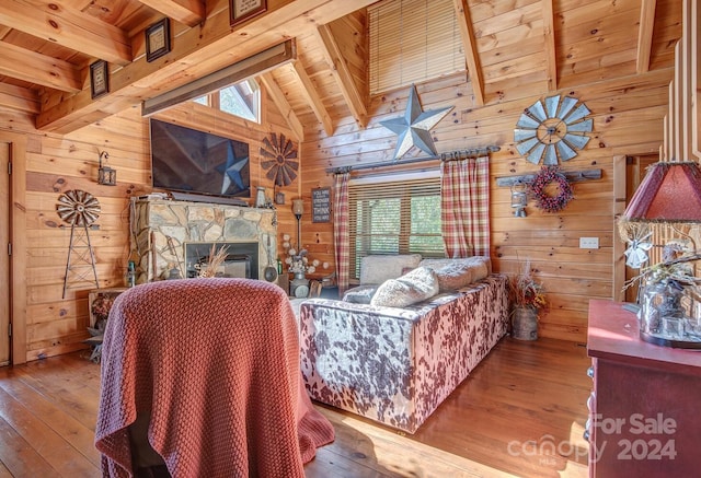 living room featuring hardwood / wood-style flooring, a healthy amount of sunlight, and wood walls