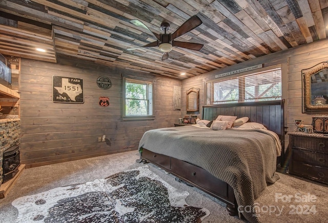 bedroom with multiple windows and wooden walls