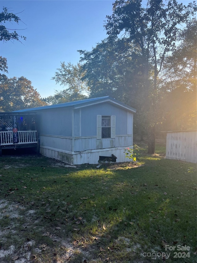 back of property with a lawn