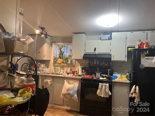 kitchen with white cabinetry, black appliances, a textured ceiling, and sink