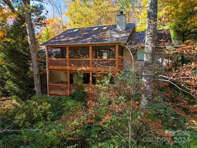 back of house with a balcony and a sunroom