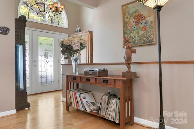 foyer entrance featuring an inviting chandelier and light hardwood / wood-style flooring