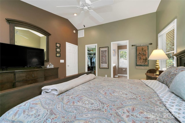 bedroom featuring a spacious closet, vaulted ceiling, a closet, and ceiling fan