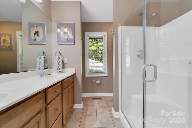 bathroom featuring vanity, tile patterned floors, and a shower with shower door