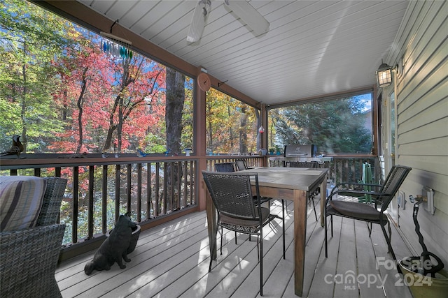 wooden deck featuring ceiling fan and grilling area