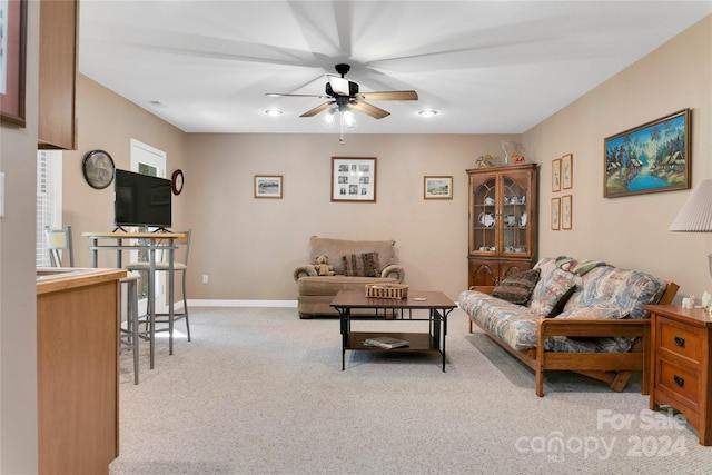 living room with light carpet and ceiling fan