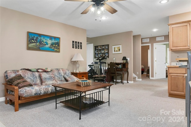 living room with light carpet and ceiling fan