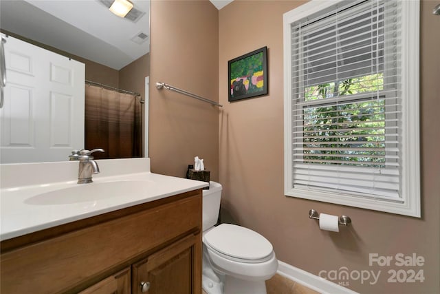 bathroom featuring vanity, toilet, and tile patterned flooring