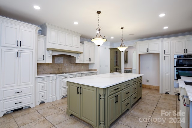 kitchen featuring tasteful backsplash, hanging light fixtures, a center island, and white cabinets