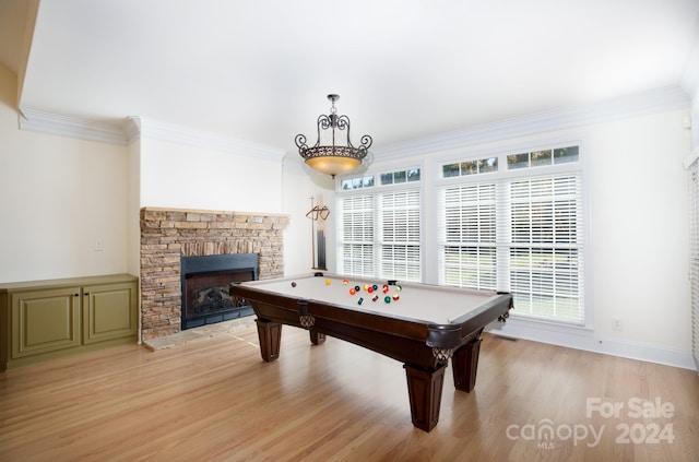 recreation room with light hardwood / wood-style flooring, a wealth of natural light, and a fireplace