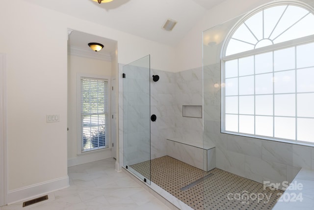 bathroom featuring tiled shower and vaulted ceiling