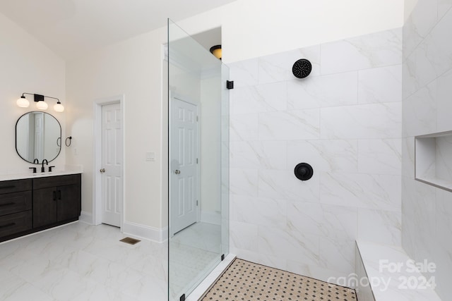 bathroom featuring vanity and a tile shower