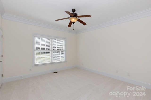 empty room with ornamental molding, light carpet, and ceiling fan