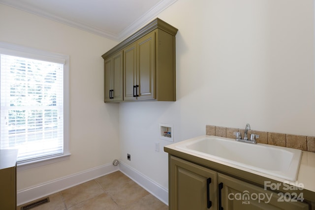 laundry room with hookup for a washing machine, light tile patterned flooring, sink, ornamental molding, and cabinets