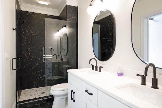 bathroom featuring vanity, a shower with shower door, ornamental molding, and toilet